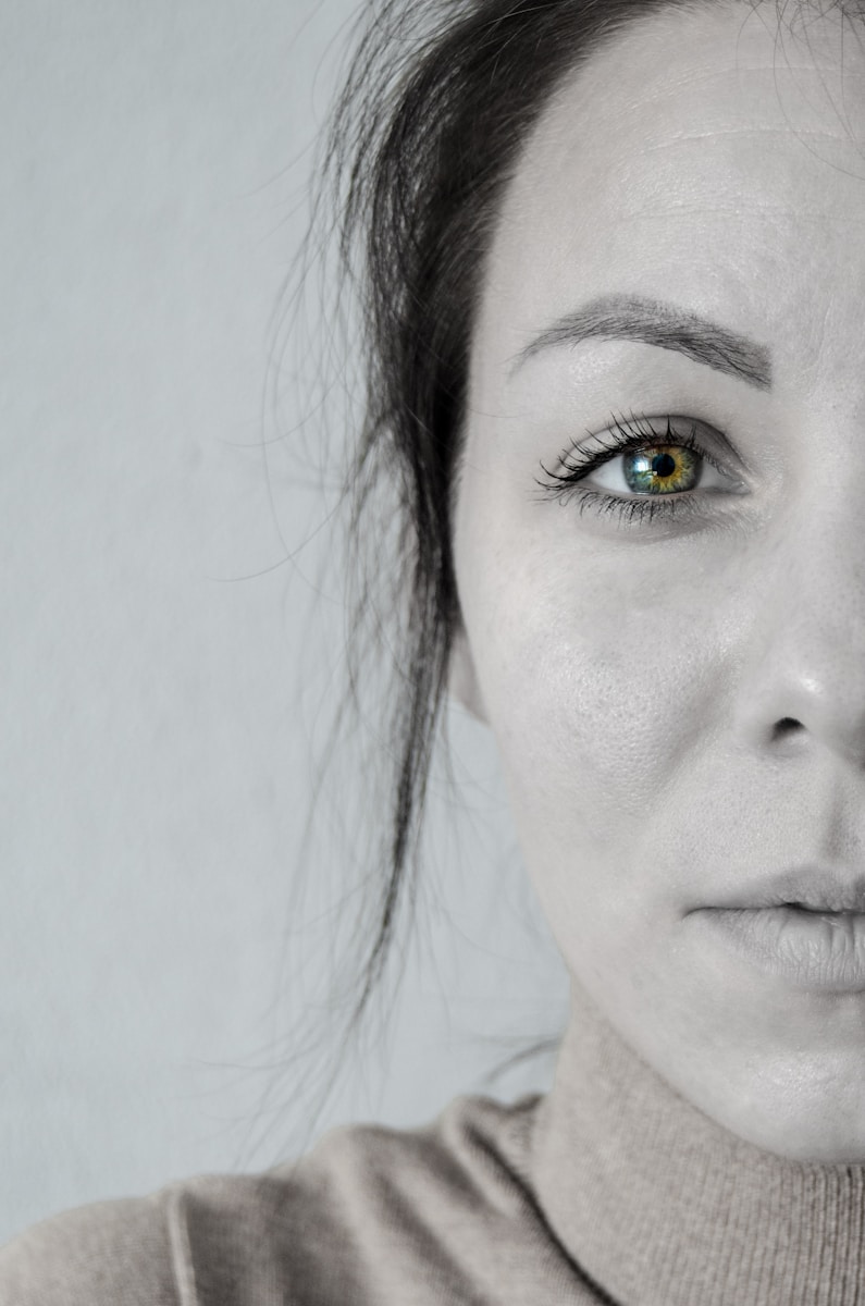 woman with black hair and white wall